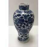 A 19th Century Chinese blue and white baluster shaped vase decorated with four toed dragons