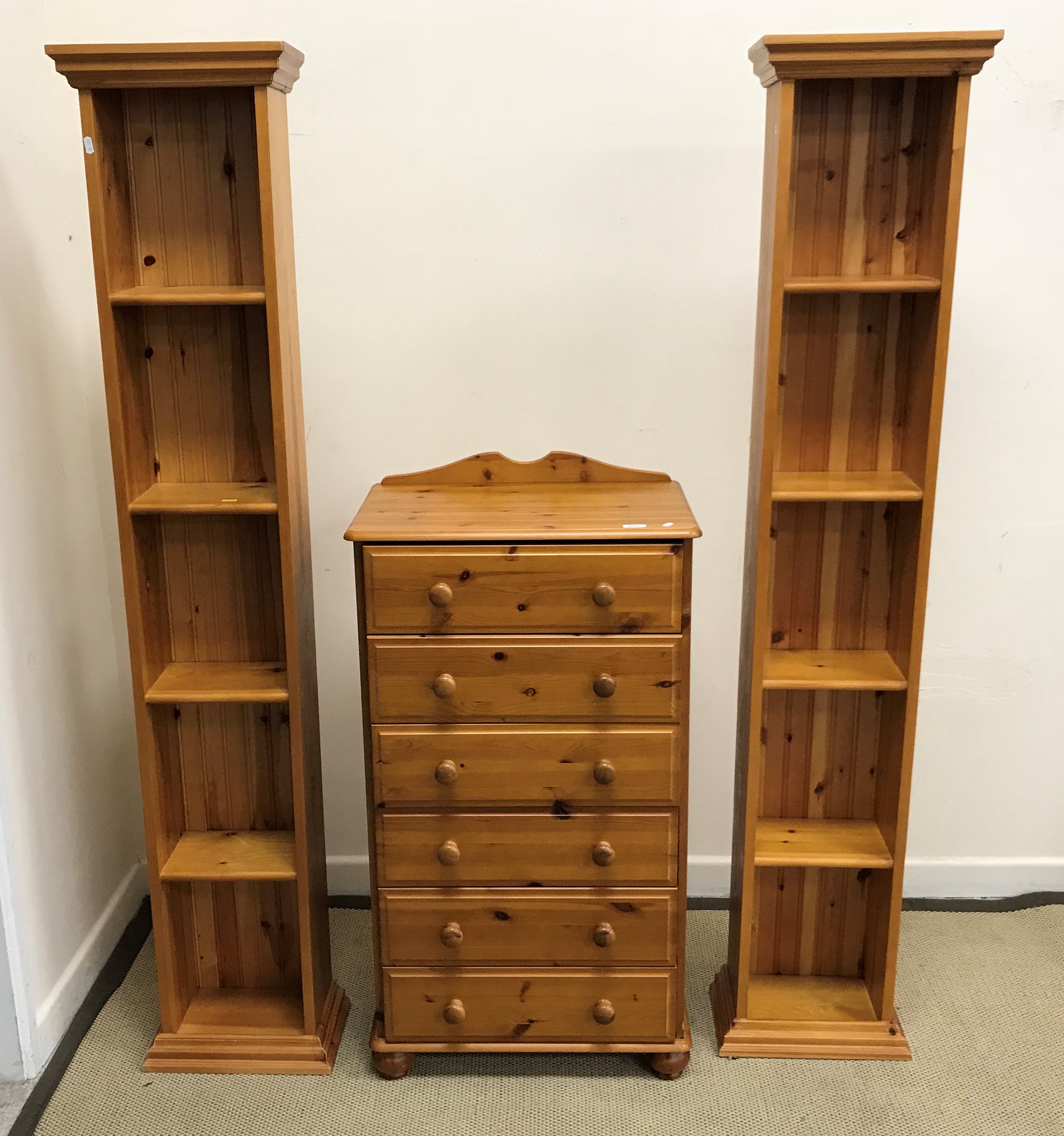 A modern pine chest of six drawers on turned feet,