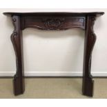 A modern mahogany fire surround with carved foliate decoration in the 19th Century manner 136 cm
