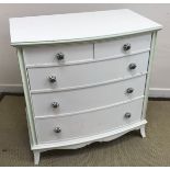 A modern white painted and pale green limed beech bow fronted chest of two short over three long