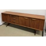 A G Plan style teak sideboard by Austin Suite, the plain top above a pair of cupboard doors,