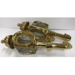 A pair of brass coaching lamps with gimbal wall mounts 44 cm long