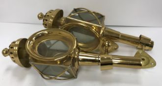 A pair of brass coaching lamps with gimbal wall mounts 44 cm long