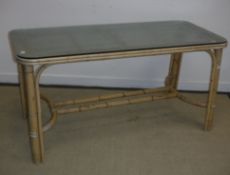 A modern bamboo framed rectangular conservatory table with textured glass top,