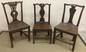 Four various stick back chairs each with pierced centre splats, one with wheel, one with star,