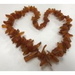 A natural amber bead necklace of graduated chip form,