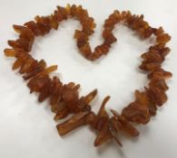 A natural amber bead necklace of graduated chip form,