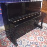 A modern black lacquered cased upright piano,