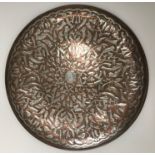 A Middle Eastern Islamic copper and white metal charger with all over floral and foliate decoration