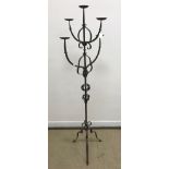 A wrought iron five light four branch candle light standard on tripod base 169 cm high