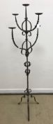 A wrought iron five light four branch candle light standard on tripod base 169 cm high