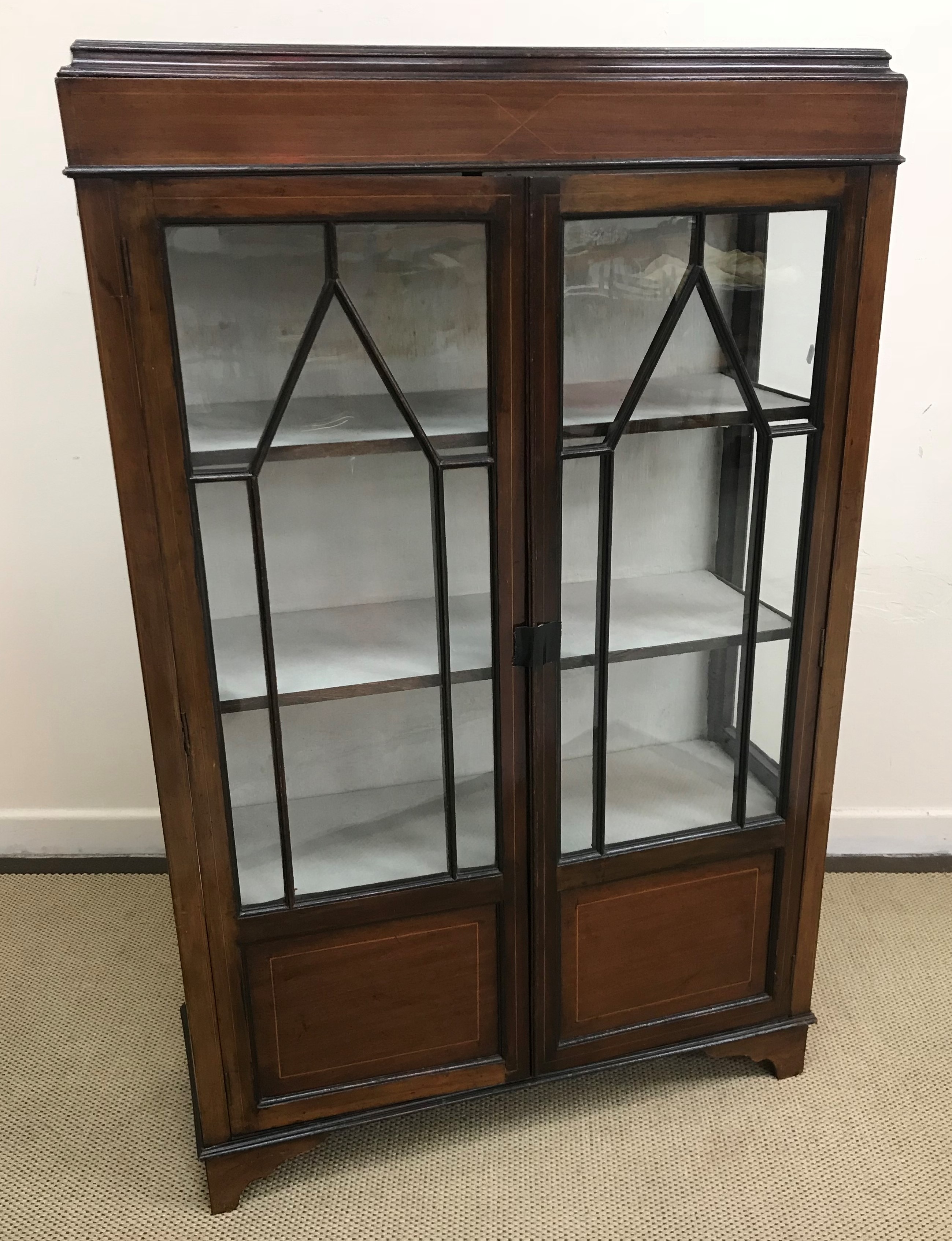 A collection of furniture comprising an Edwardian mahogany and satinwood strung display cabinet 89