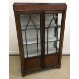 A collection of furniture comprising an Edwardian mahogany and satinwood strung display cabinet 89