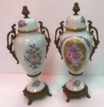 A pair of 20th Century Limoges floral spray decorated vases and covers with brass handles and bases