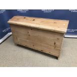 A Continental pine trunk or coffer with shaped lid and carrying handles,