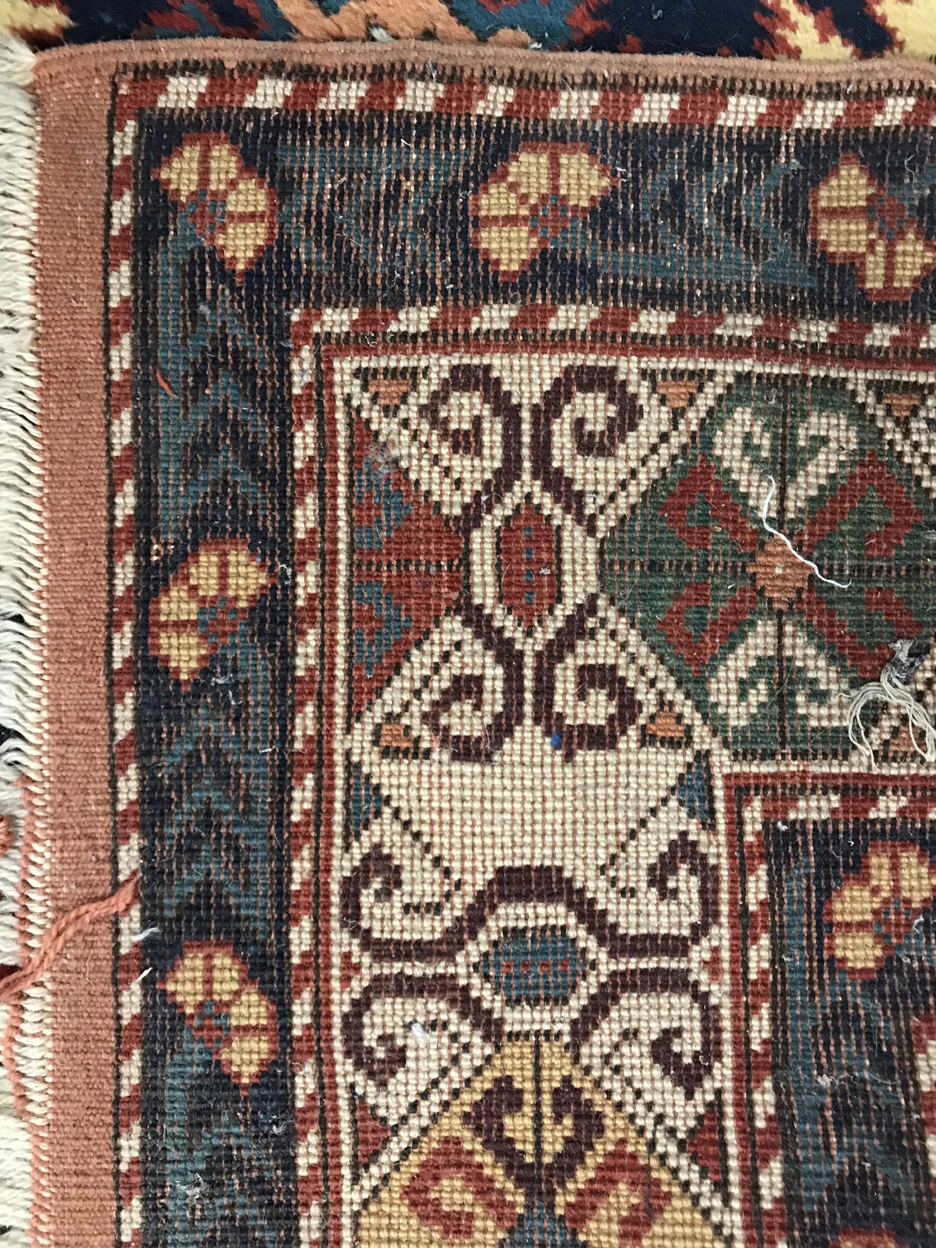 A Persian carpet, the central panel set with repeating medallions on a dark blue ground, - Image 73 of 93