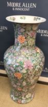 A Chinese famille rose style floor vase of baluster form with all-over floral decoration,