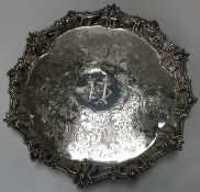 A Georgain silver salver with shell decorated rim and engraved scrolling decoration and initalled