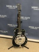 An Ozark Resonator six string semi-acoustic guitar with black body and pierced chromed plate in