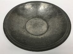 An Arts & Crafts pewter bowl with chevron decoration to the rim and centre inscribed "RW Ltd" to