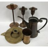 A collection of early 20th Century copper and brass ware comprising a copper candlestick with