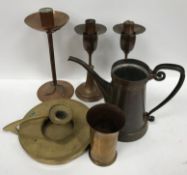 A collection of early 20th Century copper and brass ware comprising a copper candlestick with