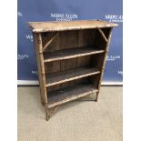 A bamboo open bookcase, the plain top above three open shelves to bracket feet,