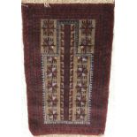 A Belouch prayer rug, the central panel set with geometric design on a mushroom ground,