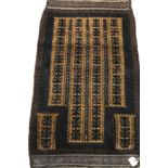 A Belouch prayer rug, the central panel set with geometric designs on a mustard ground,