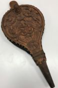 A pair of carved bellows with scrolling and intertwined foliate decoration and mask handle to top,