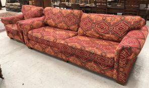 A large modern upholstered sofa in Bokhara style fabric, raised on block feet,