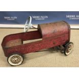 A vintage Triang tin pedal car with painted red exterior 45 cm high x 73 cm long stamped "Triang"