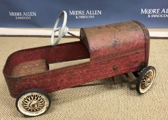 A vintage Triang tin pedal car with painted red exterior 45 cm high x 73 cm long stamped "Triang"