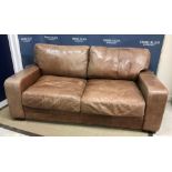 A modern brown leather two seat sofa on square squat feet,