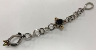 WITHDRAWN A modern Tom McEwan silver bracelet set with garnet and peridot with heavy ring links 2.