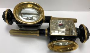 A pair of black painted carriage lamps both stamped "Patent" to one side,