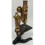 An early 20th Century lacquered brass and black lacquered monocular microscope by E Leitz of