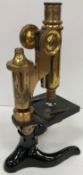 An early 20th Century lacquered brass and black lacquered monocular microscope by E Leitz of