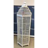 A modern painted metal bird cage of hexagonal form, raised on paw feet,