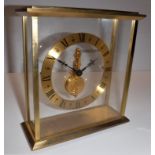 A Jaeger-LeCoultre four glass lacquered brass framed mantel clock with sixteen jewel movement,
