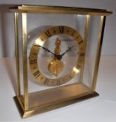 A Jaeger-LeCoultre four glass lacquered brass framed mantel clock with sixteen jewel movement,