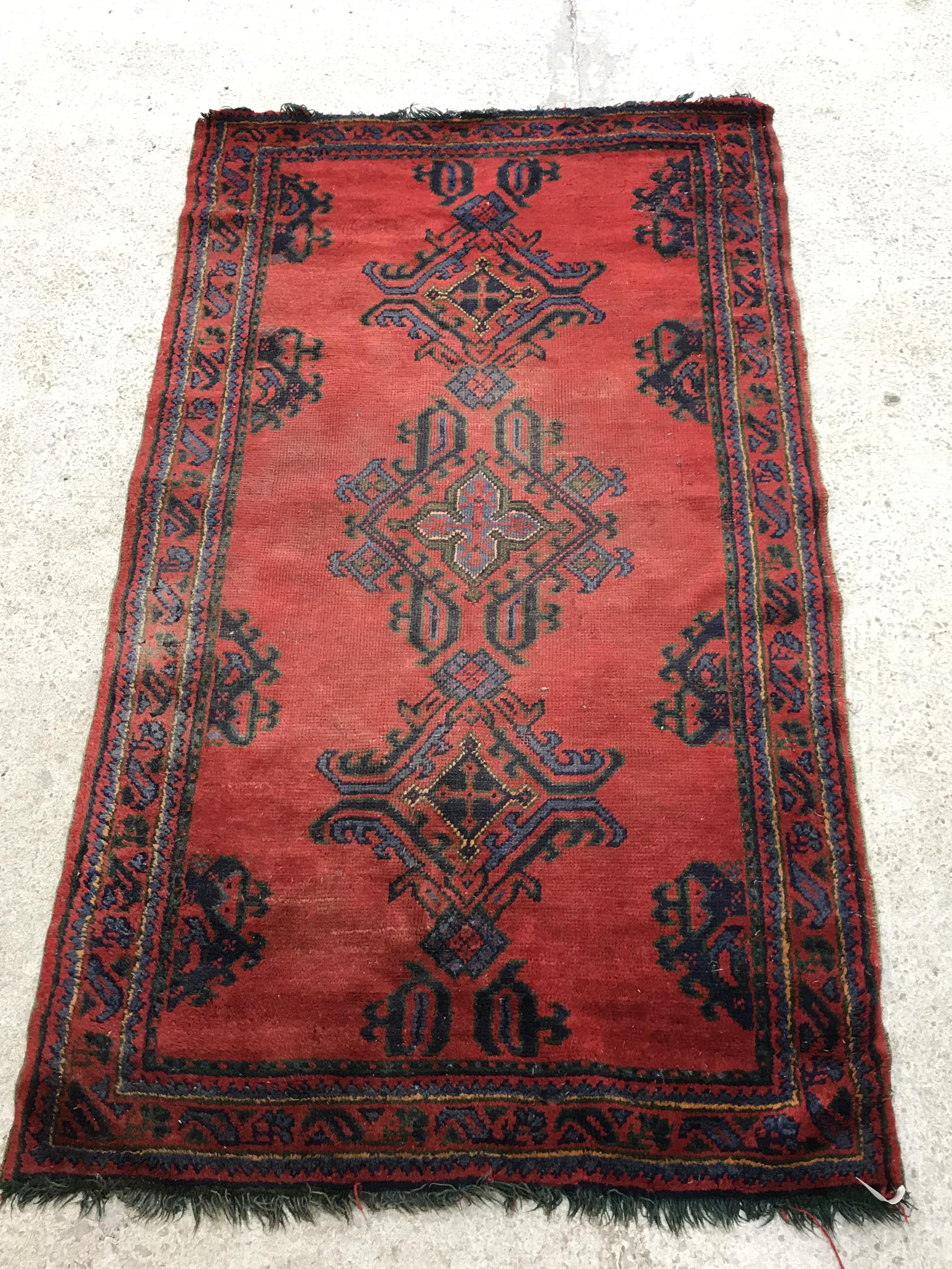 A Donegal style runner, the central panel set with repeating geometric design on a red ground, - Image 16 of 18