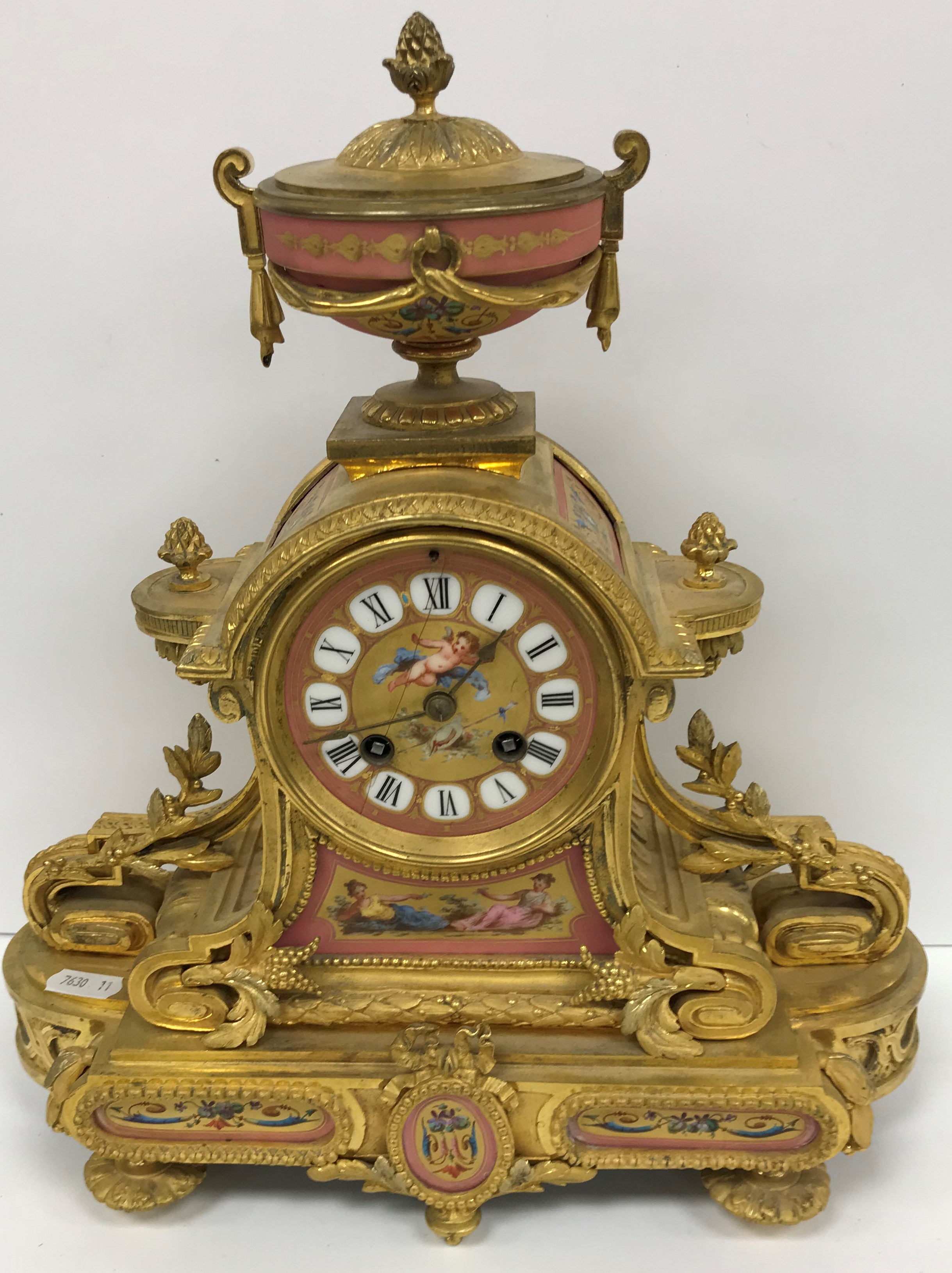 A 19th Century French lacquered brass cased mantel clock with various pink ground sèvres style