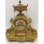 A 19th Century French lacquered brass cased mantel clock with various pink ground sèvres style