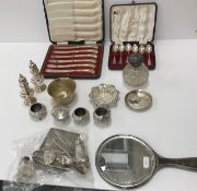 A small collection of silver wares comprising two Georgian style peppers, a small embossed bowls,
