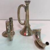 A collection of three model 'horn' type instrument models, one with loaded base,