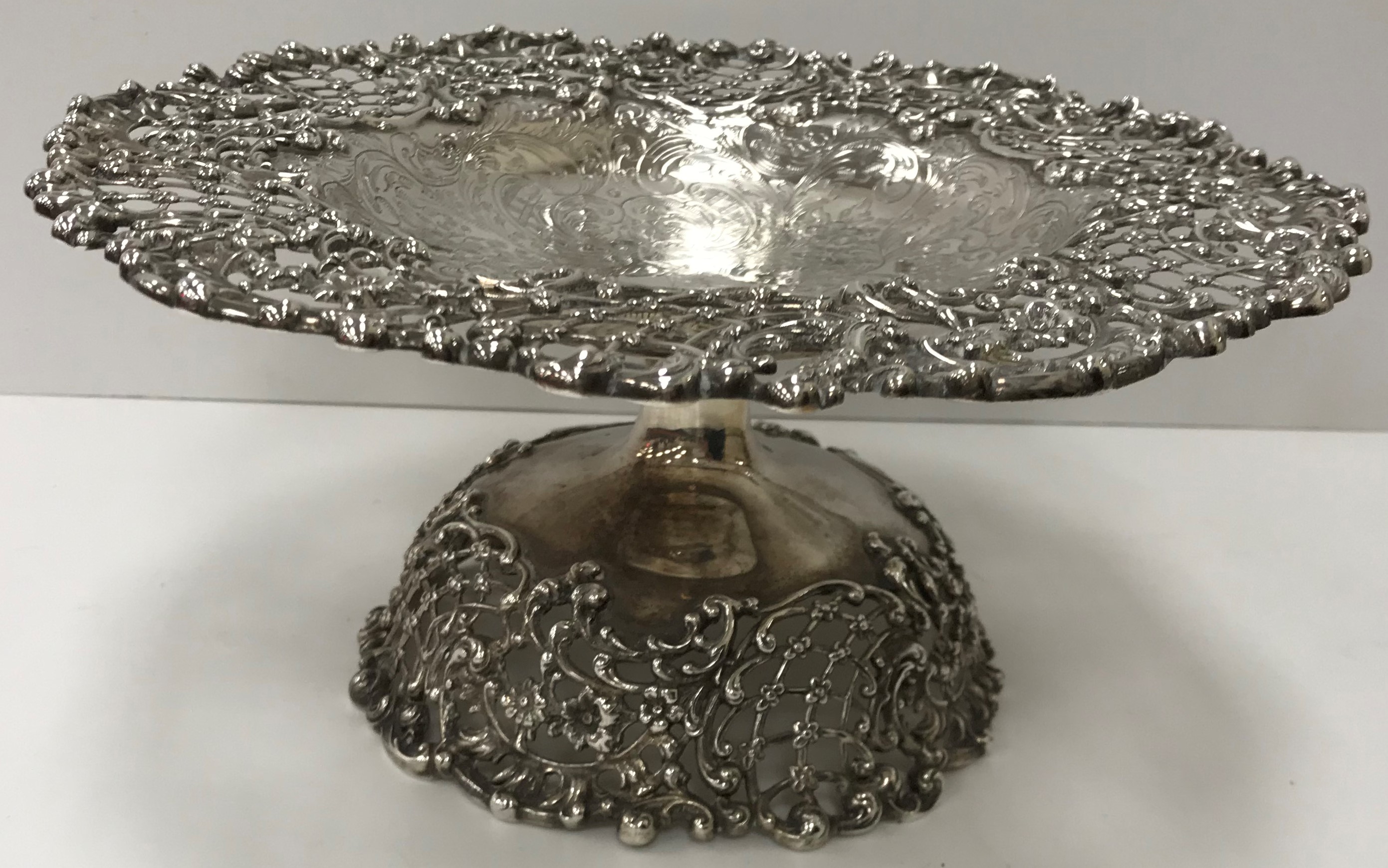 A sterling silver pierced rim tazza with C scroll decoration and engraved scrolling decoration to