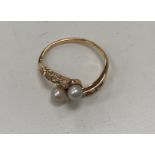 A Continental pink gold diamond and pearl set crossover dress ring,