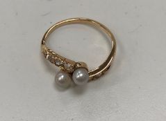A Continental pink gold diamond and pearl set crossover dress ring,