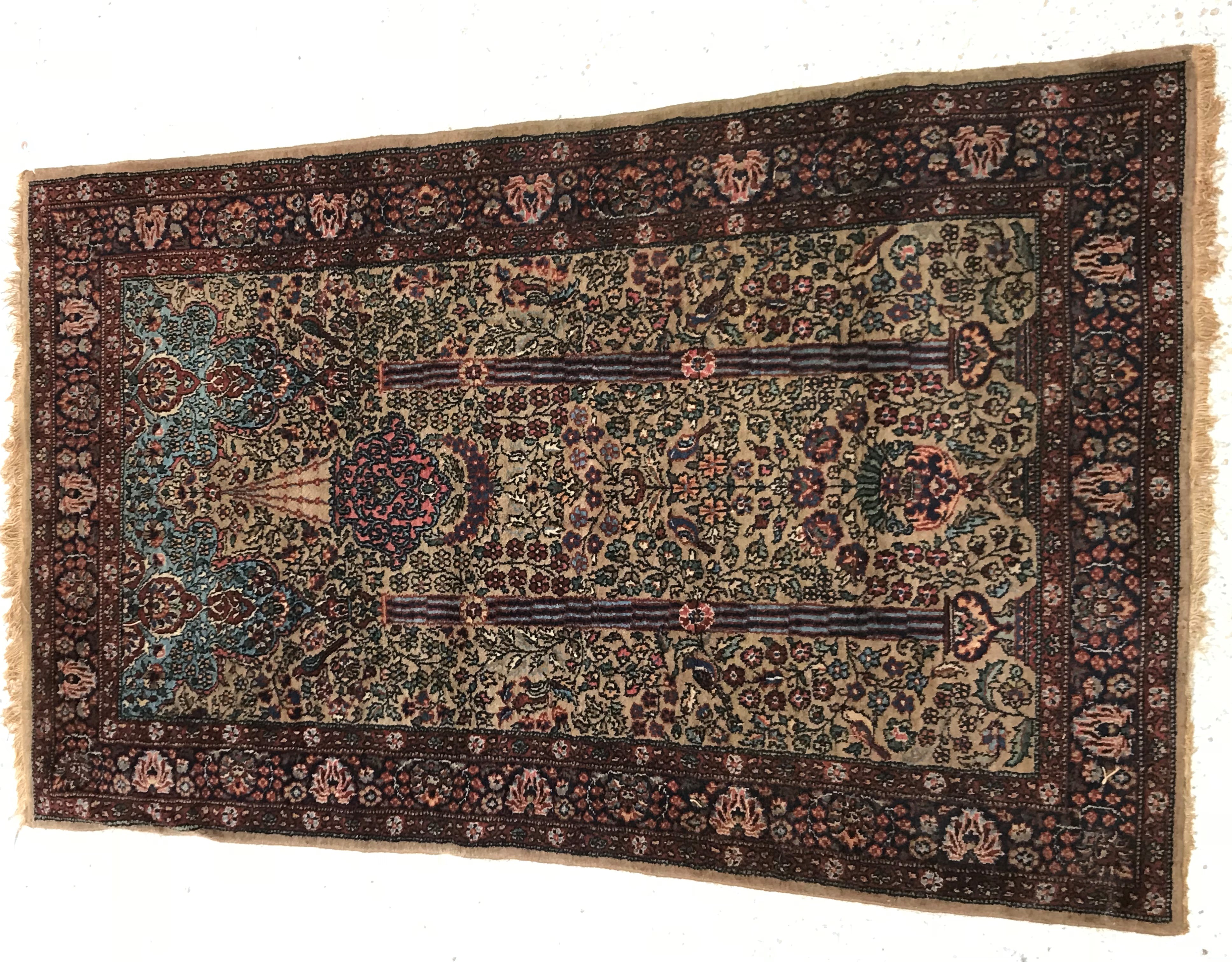 An Oriental prayer rug of Mihrab style design,